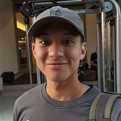 Alex, wearing a cap at the gym